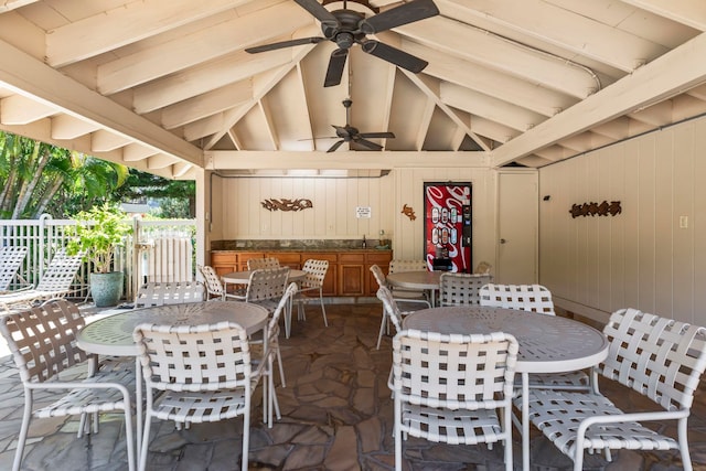 view of patio / terrace featuring a sink, outdoor dining area, ceiling fan, and fence