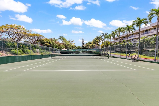 view of tennis court featuring fence