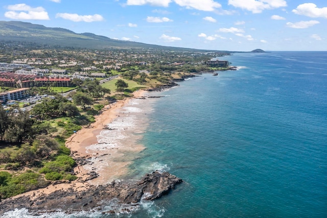birds eye view of property featuring a water and mountain view and a view of the beach