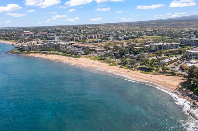 drone / aerial view with a water view and a beach view