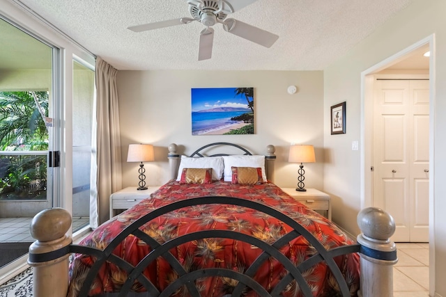 bedroom featuring a textured ceiling, tile patterned flooring, and ceiling fan