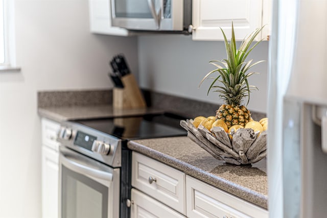 kitchen featuring white cabinets and appliances with stainless steel finishes