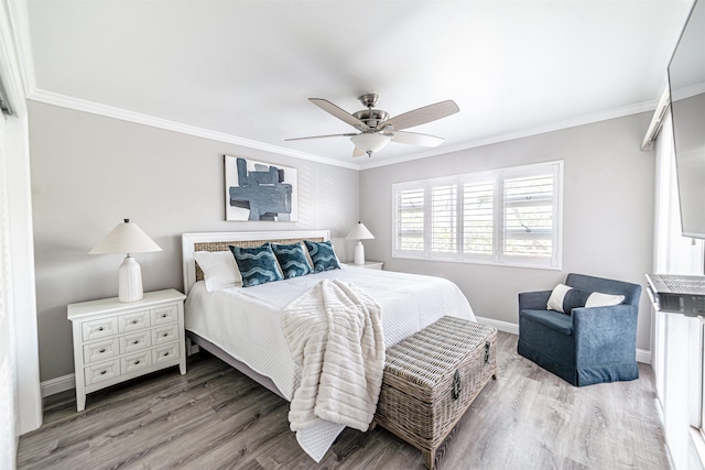 bedroom with crown molding, baseboards, light wood finished floors, and ceiling fan