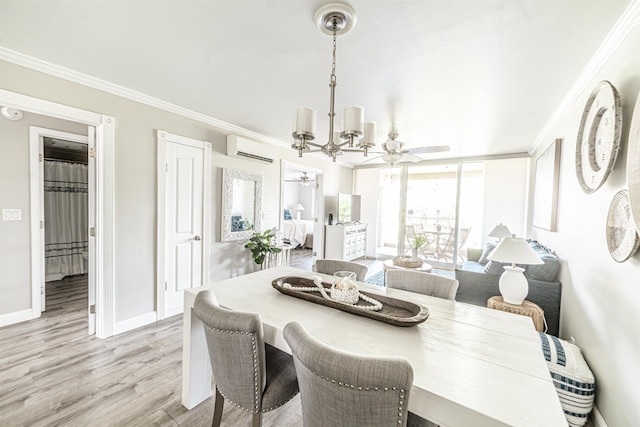 dining area with crown molding, ceiling fan with notable chandelier, baseboards, an AC wall unit, and light wood-style flooring