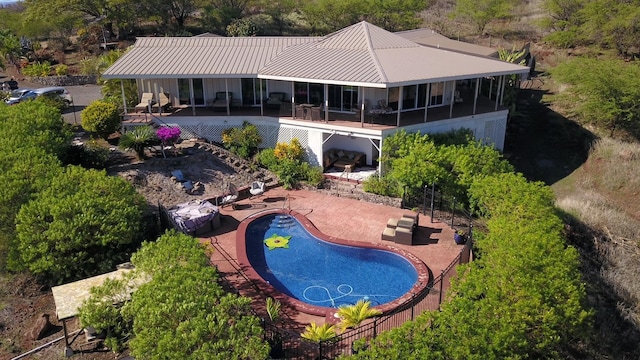 exterior space featuring a fenced in pool and a patio area