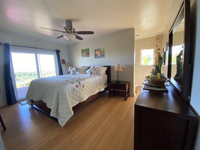 bedroom featuring ceiling fan, light wood-type flooring, and access to outside