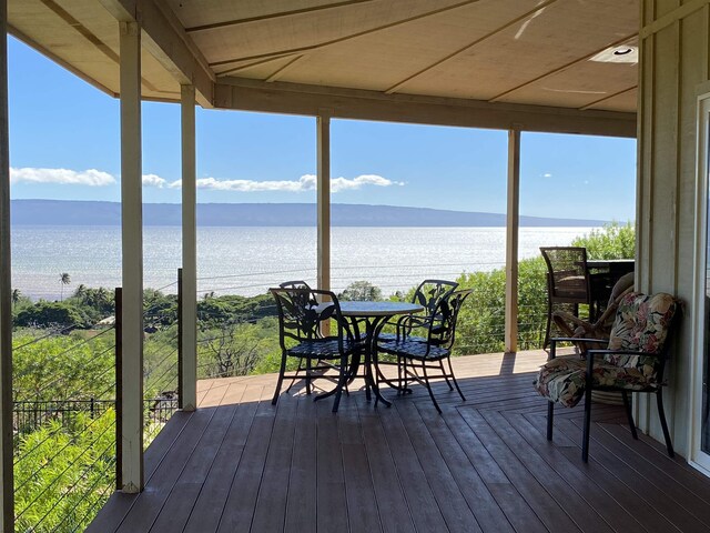 wooden terrace featuring a water view