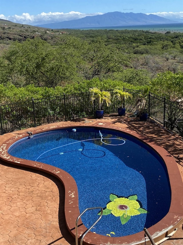 view of swimming pool with a mountain view