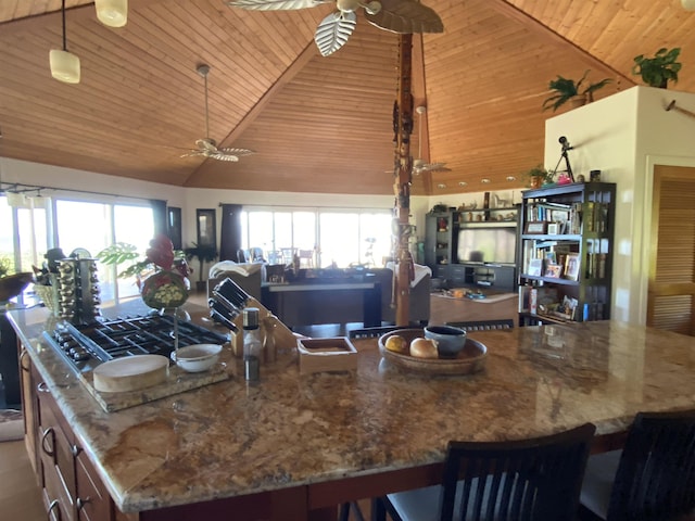 kitchen featuring a large island, ceiling fan, wooden ceiling, and high vaulted ceiling