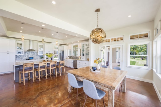 dining area featuring a tray ceiling, recessed lighting, concrete floors, baseboards, and a chandelier