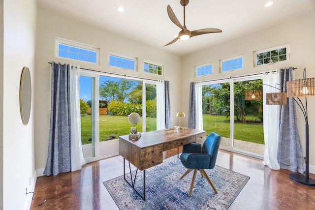 office featuring a wealth of natural light, a ceiling fan, a high ceiling, and recessed lighting