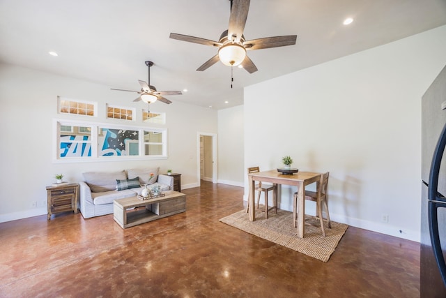 living area with recessed lighting, baseboards, concrete flooring, and ceiling fan