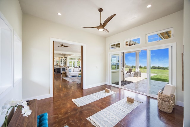 dining area with plenty of natural light, finished concrete flooring, baseboards, and ceiling fan