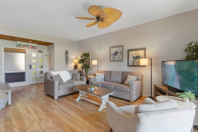 living room featuring ceiling fan and light hardwood / wood-style floors