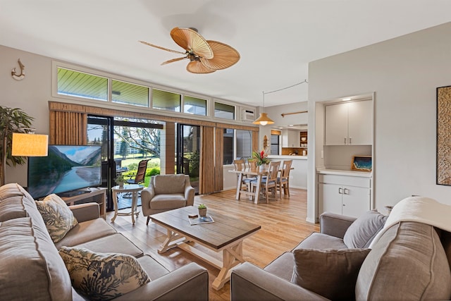 living room featuring light hardwood / wood-style flooring and ceiling fan