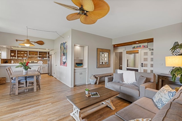 living room with light wood-type flooring and ceiling fan