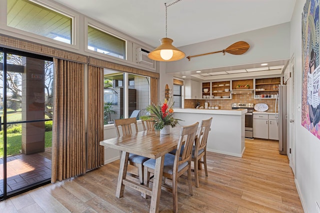 dining space featuring light wood-type flooring