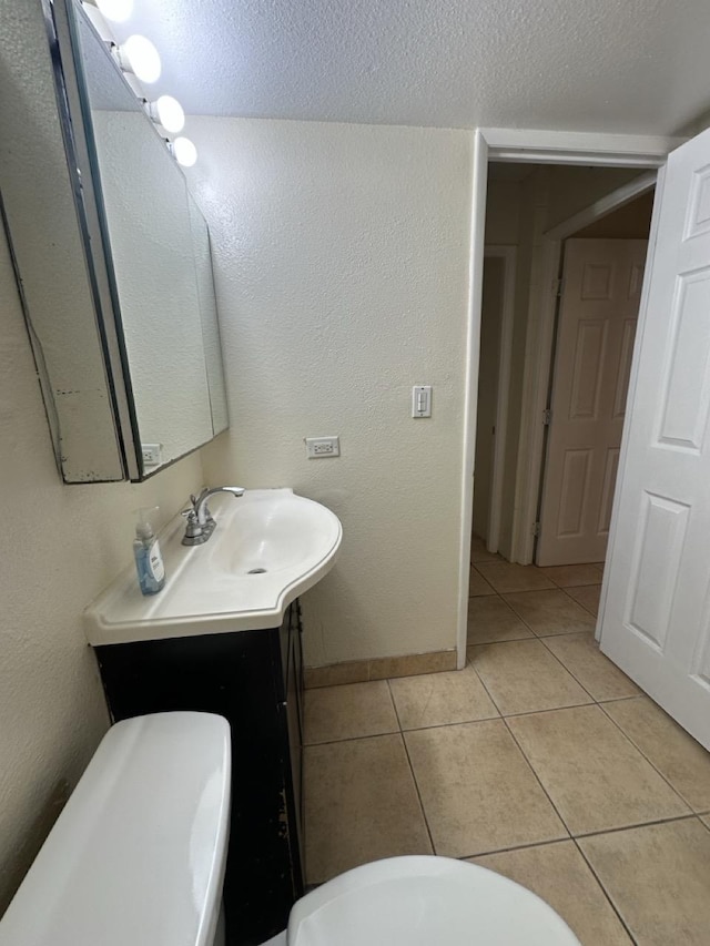111 Kahului Beach Rd Unit A407, Kahului, HI 96732 - bathroom with tile patterned flooring, vanity, baseboards, and a textured ceiling