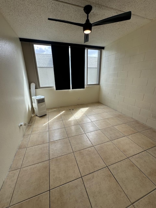 111 Kahului Beach Rd Unit A407, Kahului, HI 96732 - tiled empty room featuring a wealth of natural light and a textured ceiling