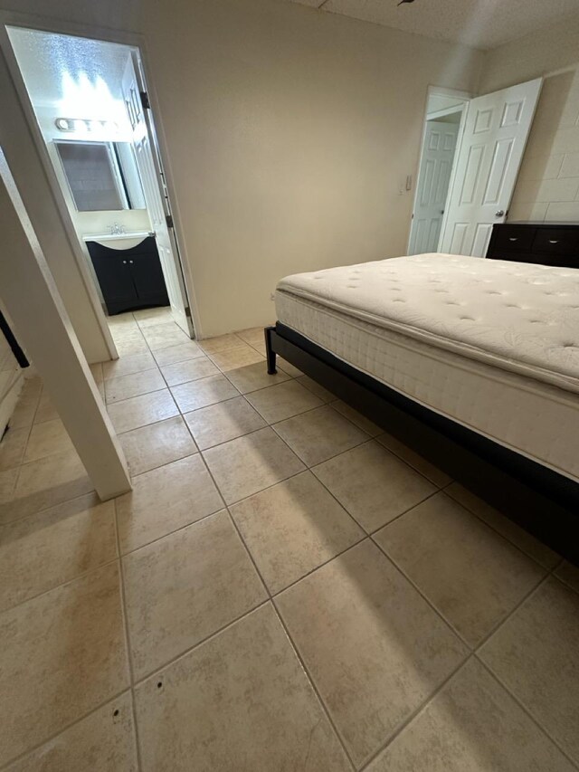 111 Kahului Beach Rd Unit A407, Kahului, HI 96732 - bedroom featuring light tile patterned floors and connected bathroom