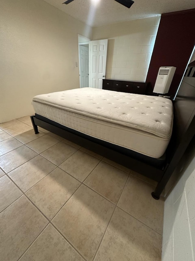 111 Kahului Beach Rd Unit A407, Kahului, HI 96732 - tiled bedroom featuring a ceiling fan and concrete block wall