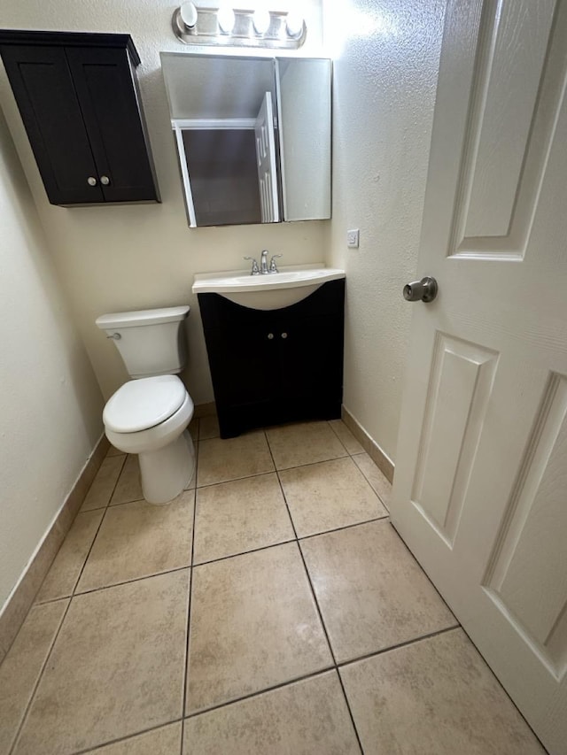 111 Kahului Beach Rd Unit A407, Kahului, HI 96732 - half bath featuring tile patterned floors, toilet, vanity, and baseboards