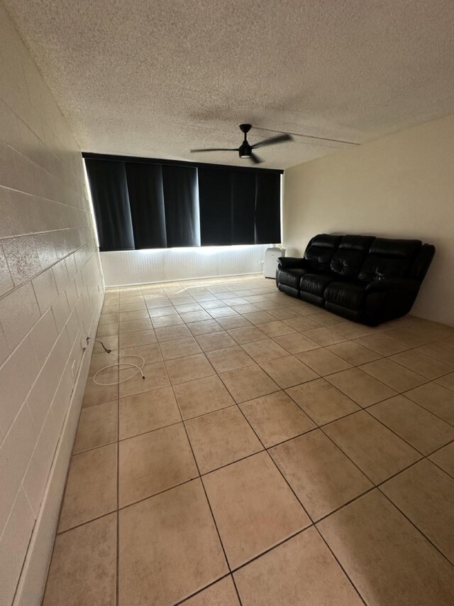 111 Kahului Beach Rd Unit A407, Kahului, HI 96732 - unfurnished living room with tile patterned floors, a ceiling fan, and a textured ceiling