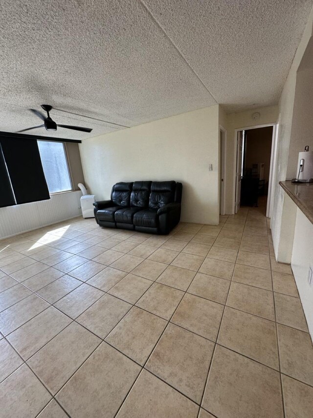 111 Kahului Beach Rd Unit A407, Kahului, HI 96732 - living area with ceiling fan, a textured ceiling, and light tile patterned flooring