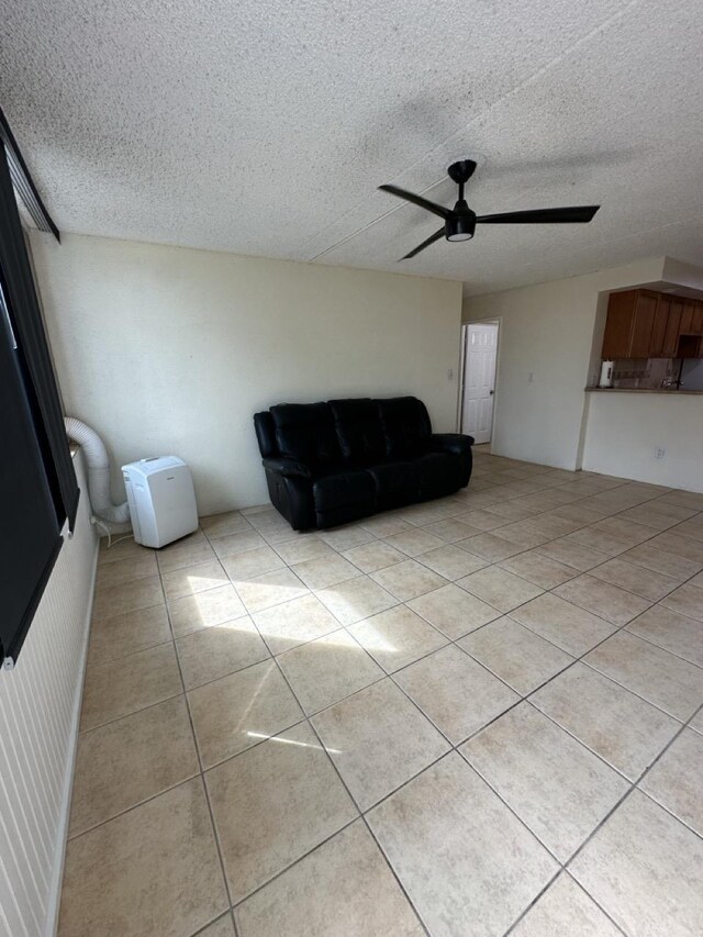 111 Kahului Beach Rd Unit A407, Kahului, HI 96732 - living area featuring a ceiling fan, light tile patterned flooring, and a textured ceiling