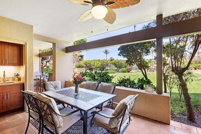 view of patio featuring ceiling fan and sink