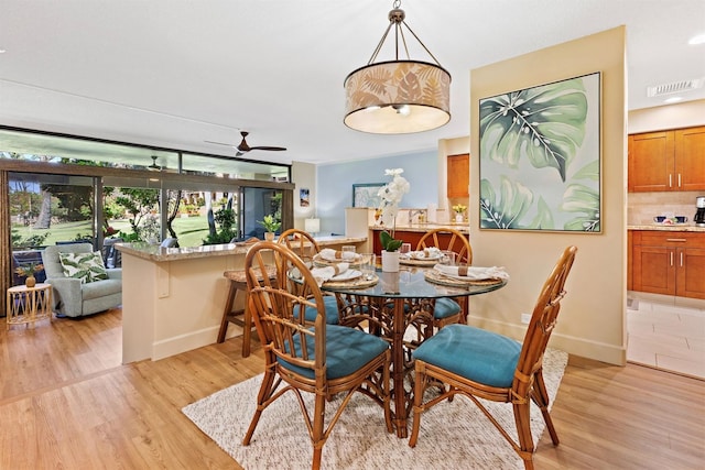 dining room featuring light wood-type flooring and ceiling fan