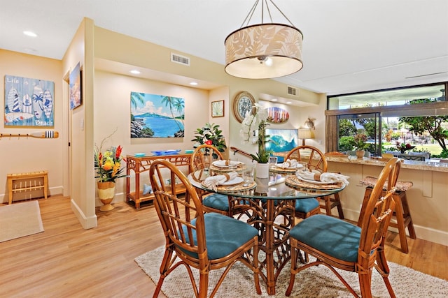 dining area with light hardwood / wood-style floors