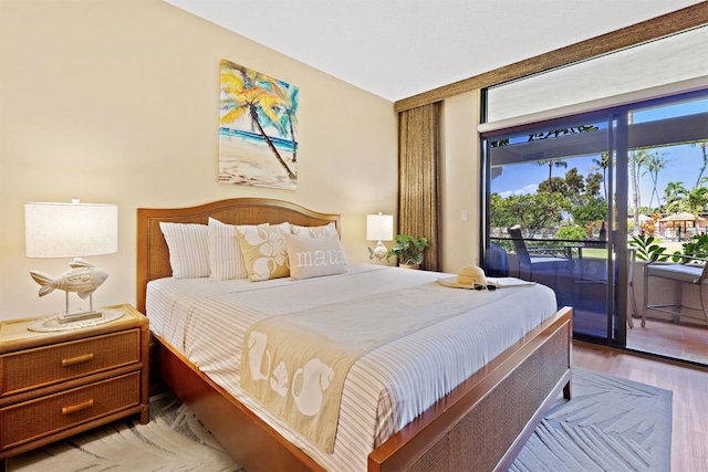 bedroom featuring access to outside and light hardwood / wood-style floors