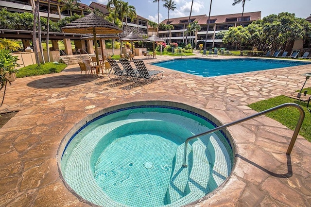 view of swimming pool featuring a patio area and a community hot tub