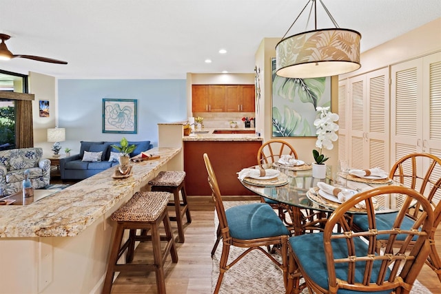 dining space featuring ceiling fan and light hardwood / wood-style flooring