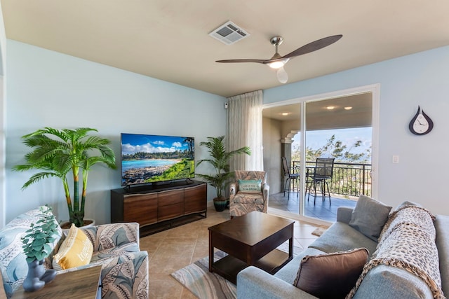 tiled living room featuring ceiling fan and visible vents