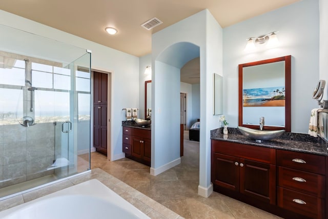 bathroom featuring a stall shower, vanity, ensuite bathroom, baseboards, and visible vents