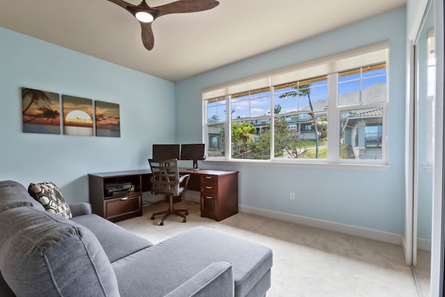office featuring baseboards, a ceiling fan, and carpet