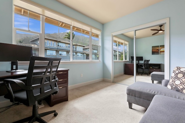 office space featuring light carpet and baseboards
