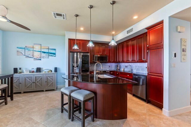 kitchen featuring a sink, dark brown cabinets, appliances with stainless steel finishes, and visible vents