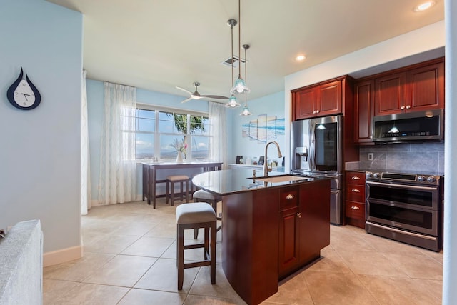kitchen with appliances with stainless steel finishes, dark countertops, visible vents, decorative backsplash, and dark brown cabinets