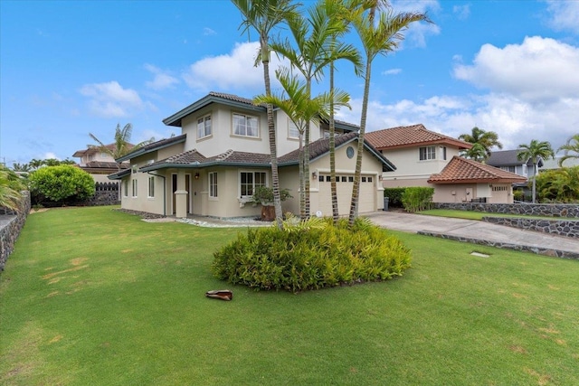 mediterranean / spanish house with a garage and a front lawn