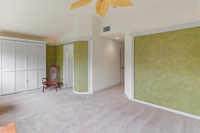 interior space featuring light carpet, high vaulted ceiling, and ceiling fan