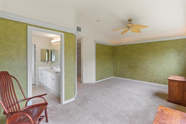 living area with sink, light carpet, and ceiling fan