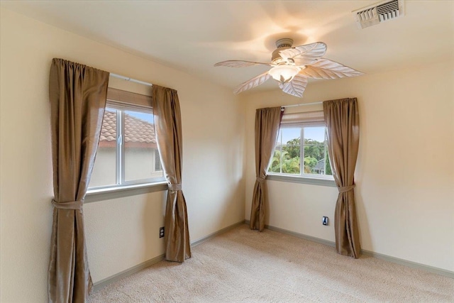 spare room with light colored carpet and ceiling fan