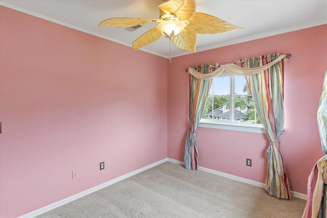 carpeted empty room with crown molding and ceiling fan