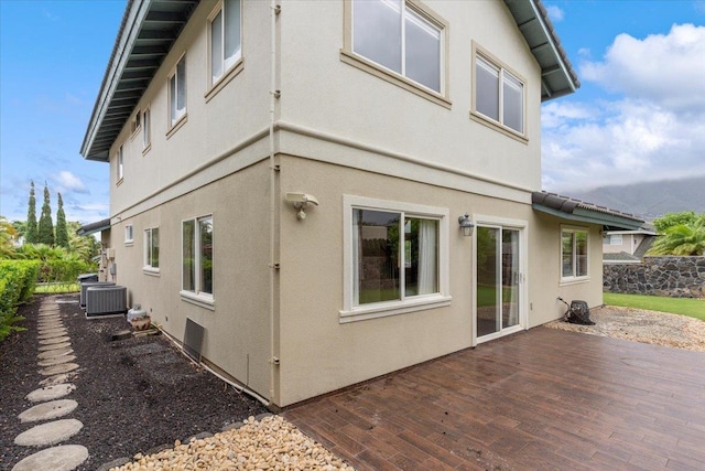 view of home's exterior featuring a wooden deck and central air condition unit