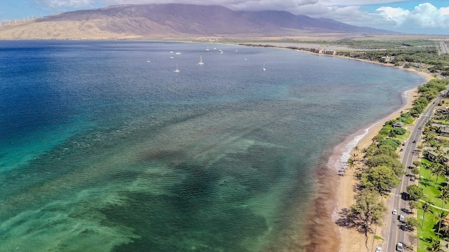 aerial view featuring a water and mountain view