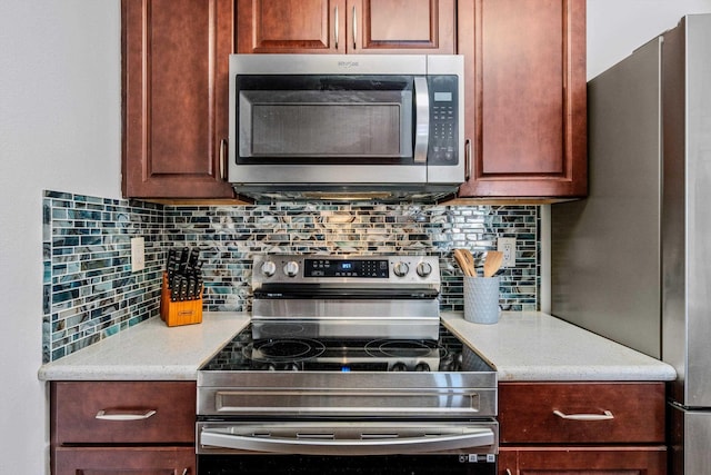 kitchen featuring stainless steel appliances and decorative backsplash