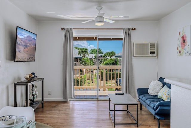 living room featuring hardwood / wood-style flooring, ceiling fan, and a wall mounted air conditioner